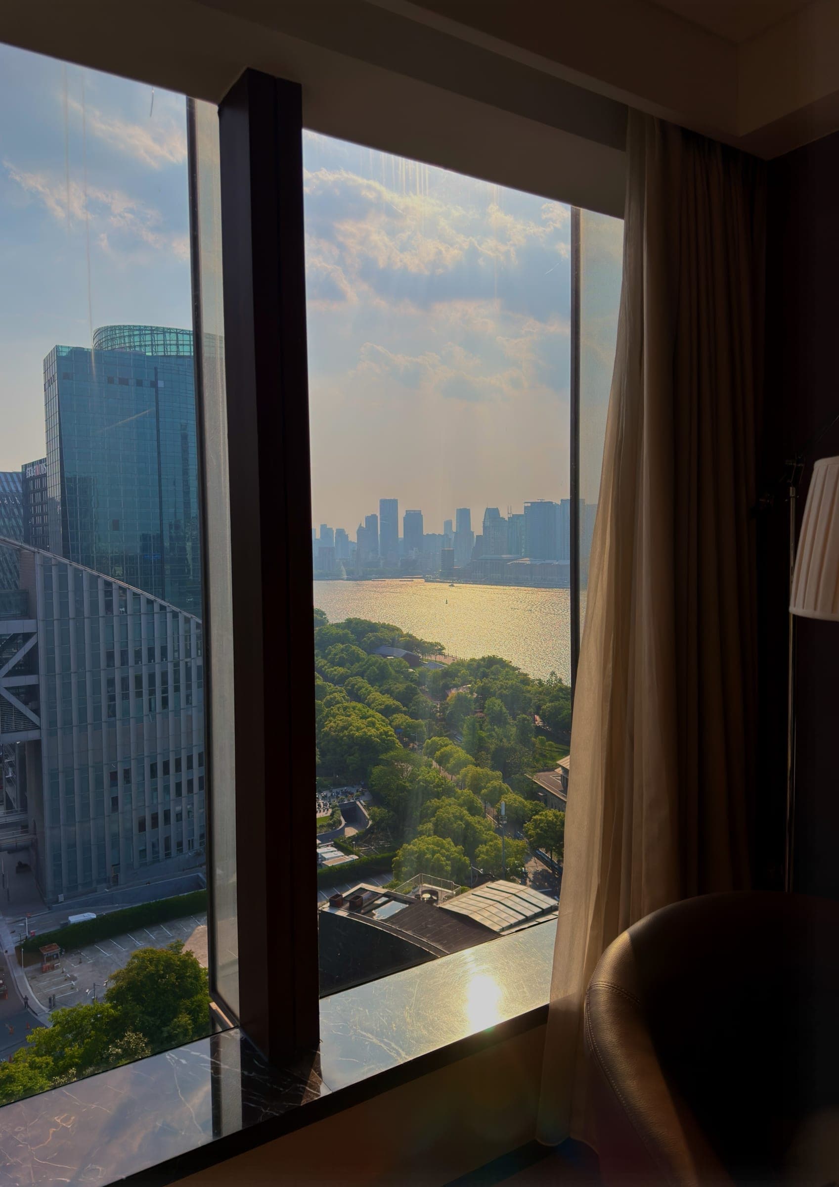 A dusk view of the Huangpu River and skyline through the window