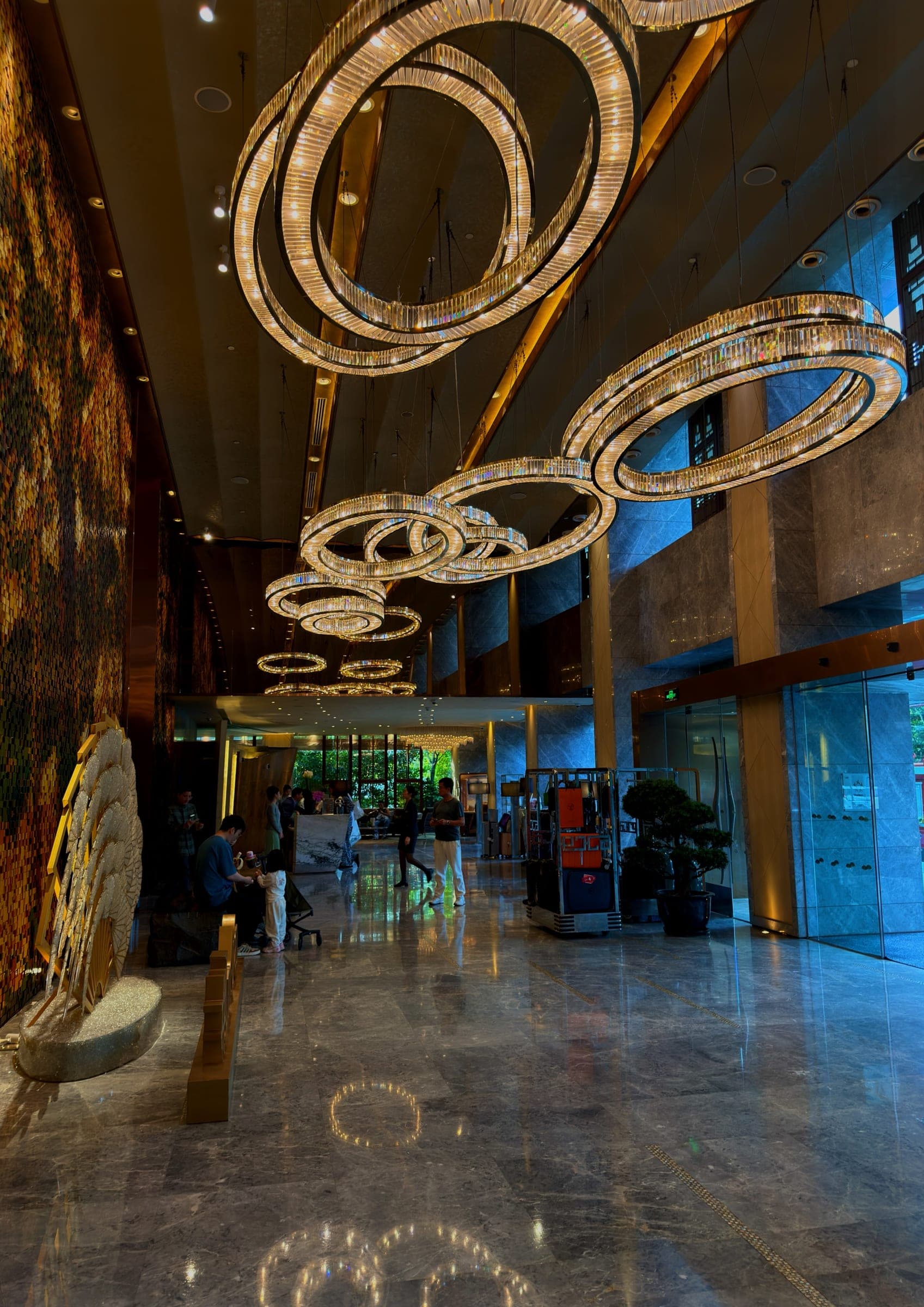 A grand lobby hung with cascading ring chandeliers