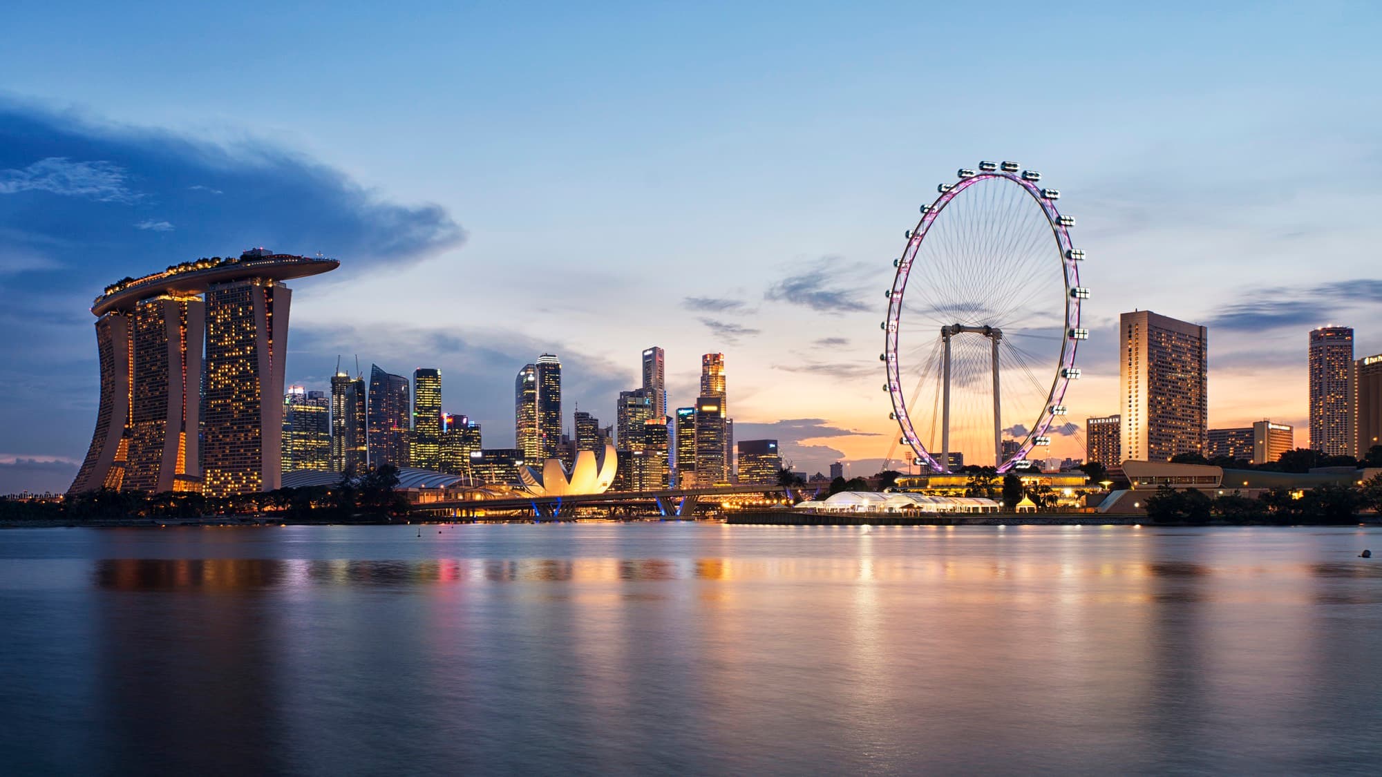 The Singapore skyline at dusk, Marina Bay Sands reflected in still water