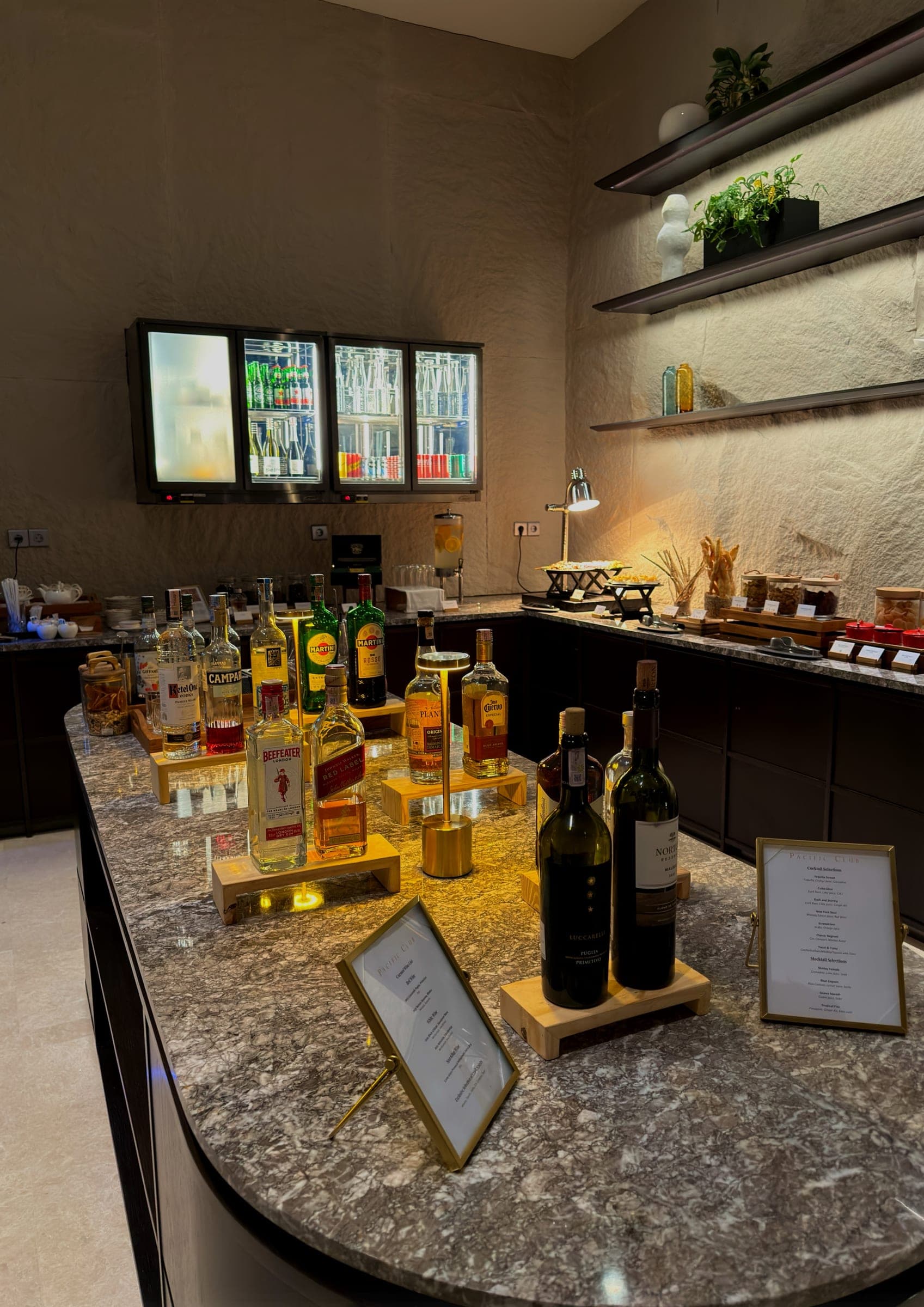 A club lounge bar laid with spirits and evening menus
