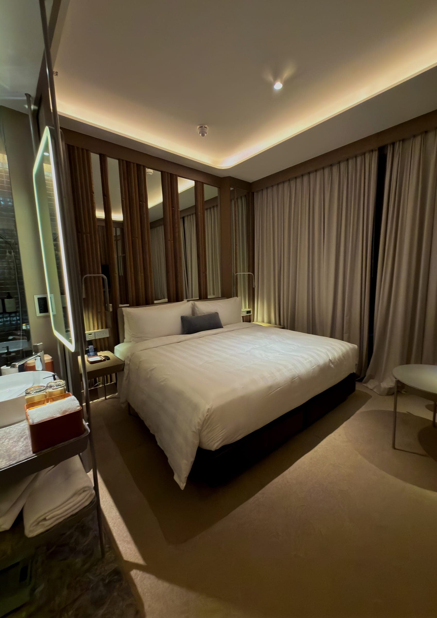 A compact guest room with a timber-slatted headboard