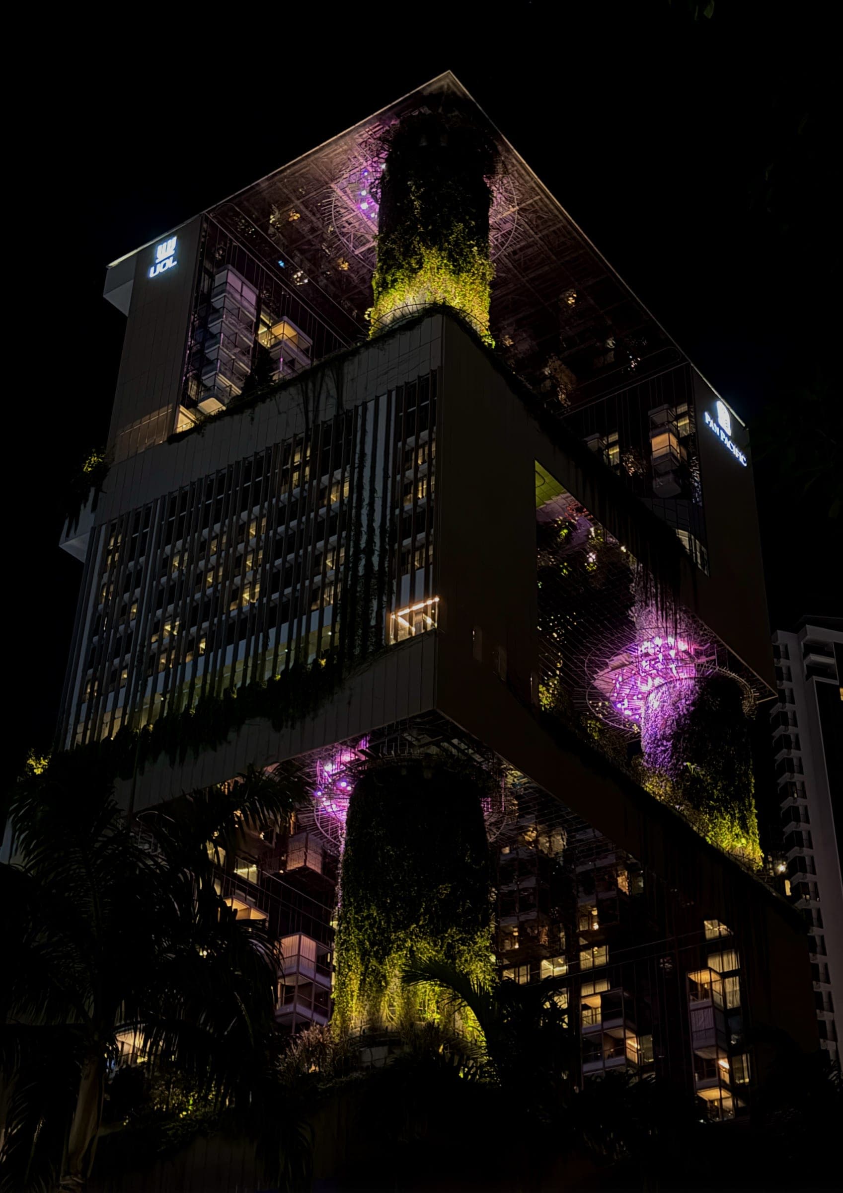 The stacked planted terraces of the hotel lit in the dark