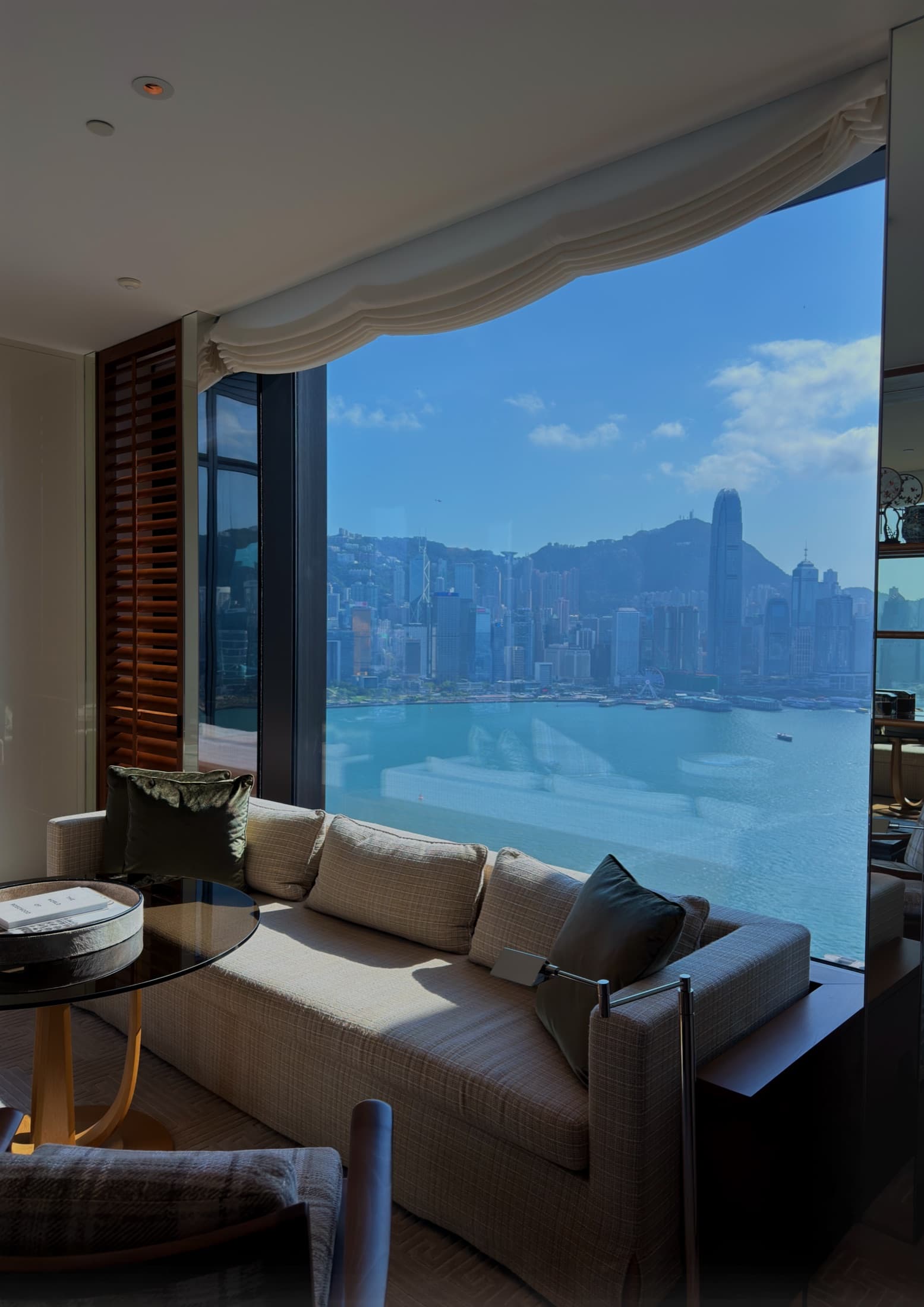 A window seat at Rosewood Hong Kong, Victoria Harbour beyond the glass